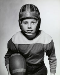 Close-up of a boy holding a football poster print