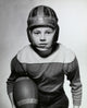 Close-up of a boy holding a football poster print