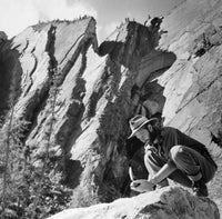 Geologist Breaking a Stone Poster Print showcasing a geologist with a hammer.