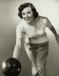 Young adult woman rolling a bowling ball poster print.
