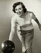Young adult woman rolling a bowling ball poster print.