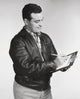 Mid adult man writing on a clipboard poster print, vibrant colors, perfect for office decor.