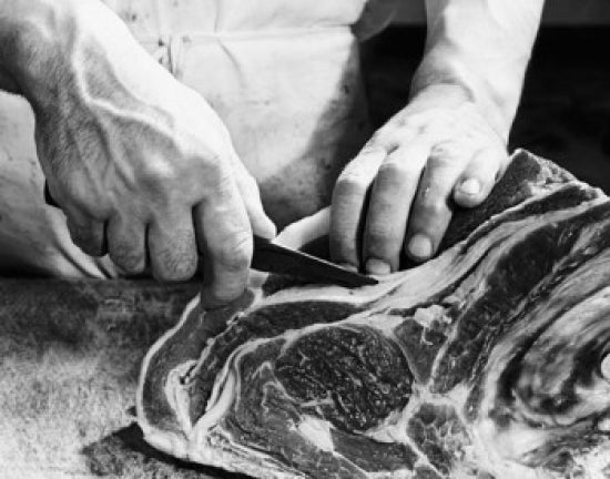Mid section view of a man's hands cutting raw meat poster print.