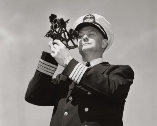 Low angle view of a ship captain looking through a sextant poster print.