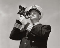 Low angle view of a ship captain looking through a sextant poster print.