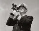 Low angle view of a ship captain looking through a sextant poster print.
