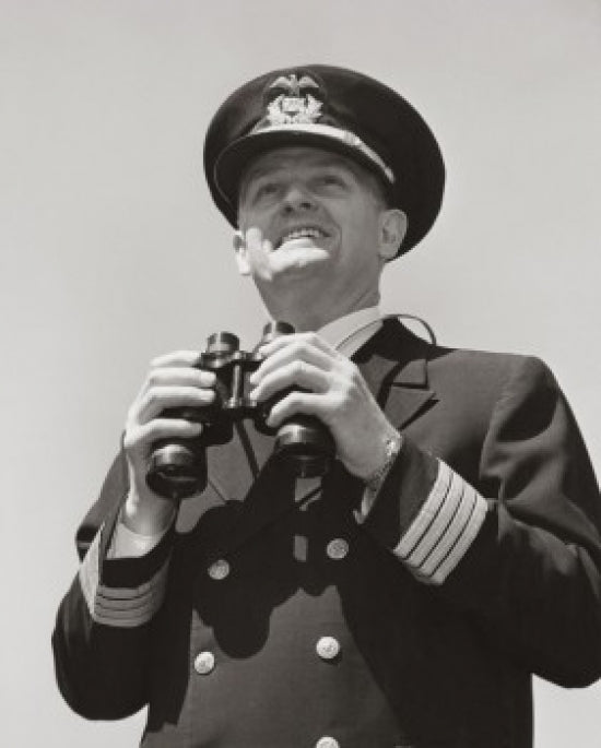 Poster print of a ship captain holding binoculars from a low angle view.