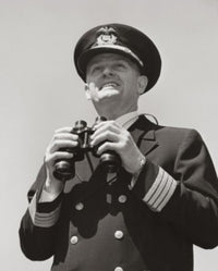 Poster print of a ship captain holding binoculars from a low angle view.