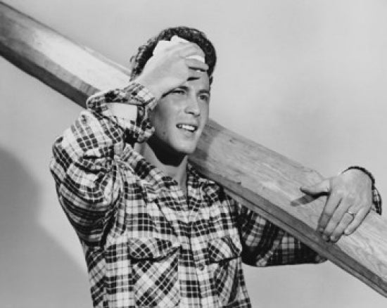 Close-up poster print of a man carrying a plank on his shoulder.