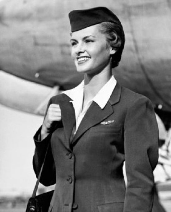 Air hostess smiling while carrying a bag poster print.