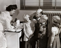 Male doctor examining a girl's ear with an otoscope poster print