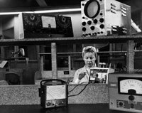Female electrician wiring electronic components in a workshop poster print