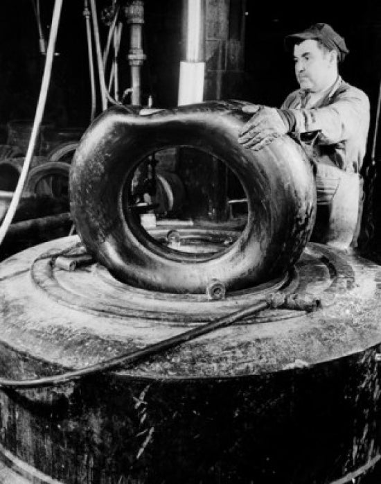 Male Worker in Tire Factory Poster Print showcasing industrial craftsmanship.