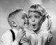 Whispering Boy and Girl Poster Print showcasing a tender childhood moment.