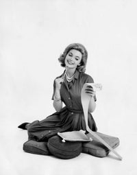 Mid adult woman looking at a list and smiling poster print.