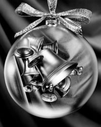 Close-up of Christmas bells superimposed on a Christmas ornament poster print.