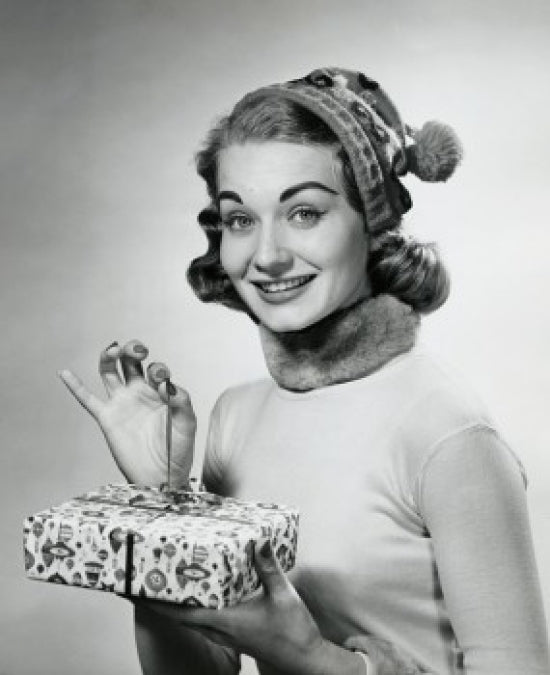 Portrait of a mid-adult woman holding a Christmas present poster print