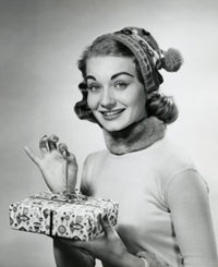 Portrait of a mid-adult woman holding a Christmas present poster print