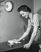 Poster print of a side profile of a young woman cleaning a table.