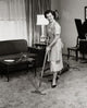 Portrait of a Young Woman Vacuuming Carpet Poster Print