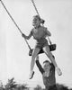 Boy pushing his sister on a swing poster print