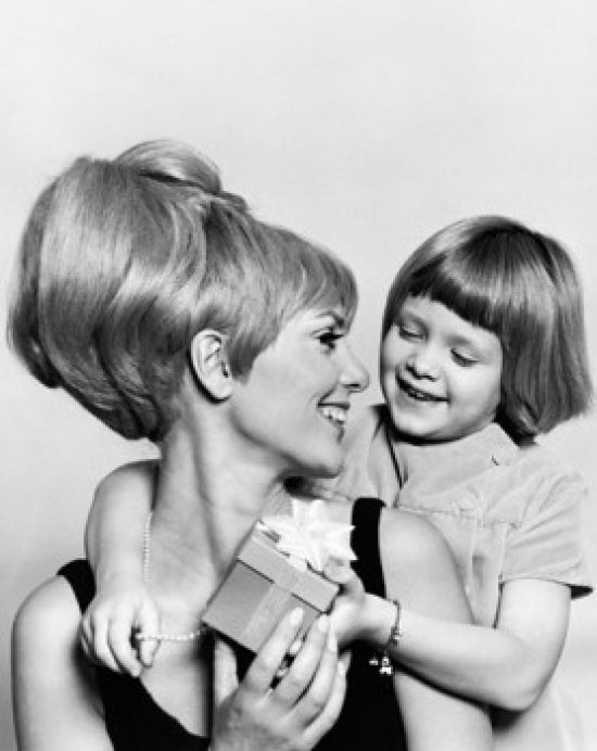 Close-up poster print of a girl giving a present to her mother.