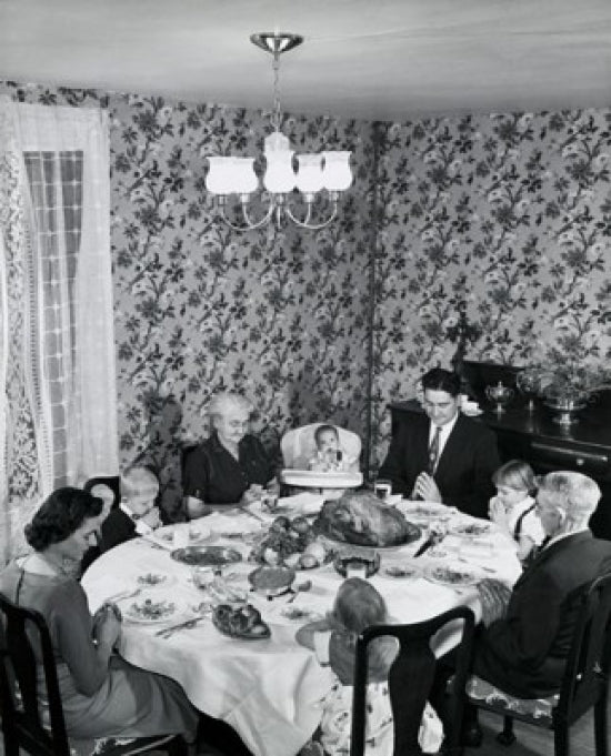 High angle view of a family praying at a dining table on Thanksgiving Day poster print.