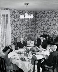 High angle view of a family praying at a dining table on Thanksgiving Day poster print.