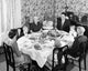 Family gathered around a dining table on Thanksgiving Day poster print.