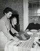Thanksgiving Day poster print featuring a mature woman serving roasted turkey to her parents.