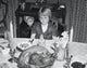 Thanksgiving Day poster print of a girl at a dining table with roasted turkey