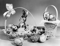Close-up of Easter eggs and toy in a basket, colorful and festive.