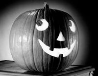 Close-Up Illuminated Jack O' Lantern Poster Print showcasing intricate details and warm glow.