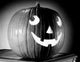 Close-Up Illuminated Jack O' Lantern Poster Print showcasing intricate details and warm glow.