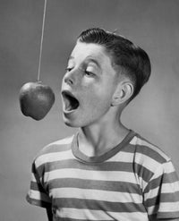Boy Trying to Bite an Apple Hanging on a String Poster Print