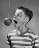 Boy Trying to Bite an Apple Hanging on a String Poster Print