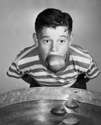 Poster print of a boy holding an apple, perfect for children's decor.
