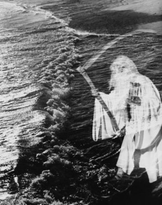 Senior man holding scythe and hourglass on the beach poster print