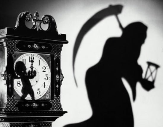 Close-up of a clock with the shadow of a person carrying a scythe poster print.