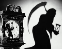 Close-up of a clock with the shadow of a person carrying a scythe poster print.
