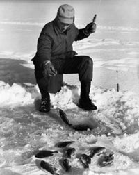 Young Man Ice Fishing on a Frozen Lake Poster Print