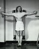 Young woman smiling while exercising in a gym poster print.