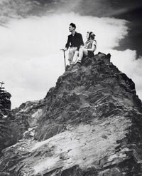 Young Couple Sitting on a Mountain Poster Print
