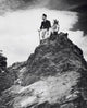 Young Couple Sitting on a Mountain Poster Print