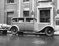 Rolls Royce parked on the road poster print showcasing luxury and elegance.