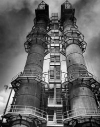 Low angle view of two smoke stacks of a factory fine art print.