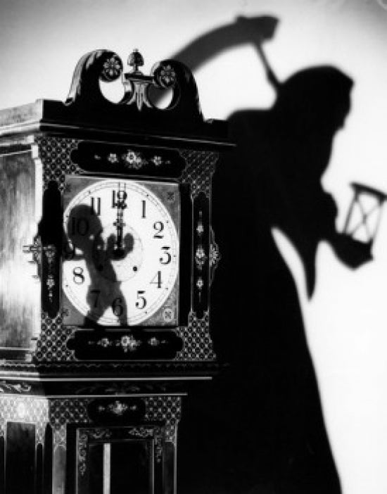 Close-Up of a Clock with Shadow of a Person Carrying a Scythe Poster Print