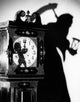 Close-Up of a Clock with Shadow of a Person Carrying a Scythe Poster Print