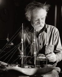 Senior man making a model sailing ship poster print.