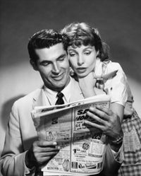 Young couple reading a newspaper poster print